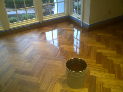 Sealant being applied to a newly refinished wood floor